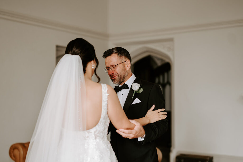 emotional father of bride seeing bride for first time on wedding morning at tortworth court