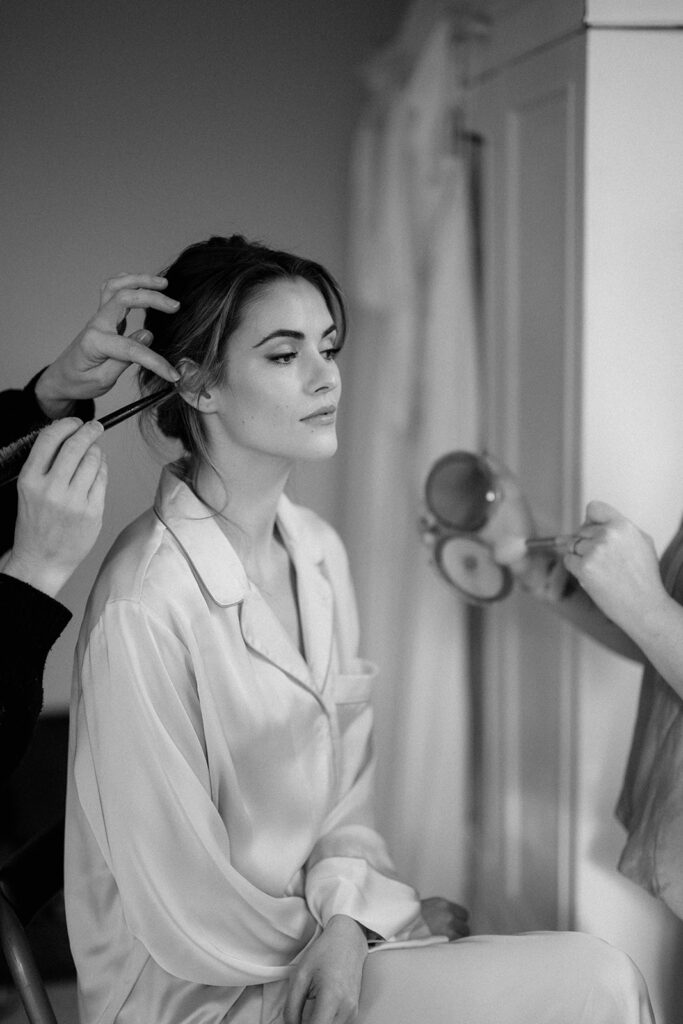 bride getting ready on wedding morning have makeup done at Sandon Manor