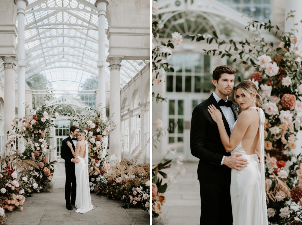 bride and groom in front of floral arch ceremony set up at syon park
