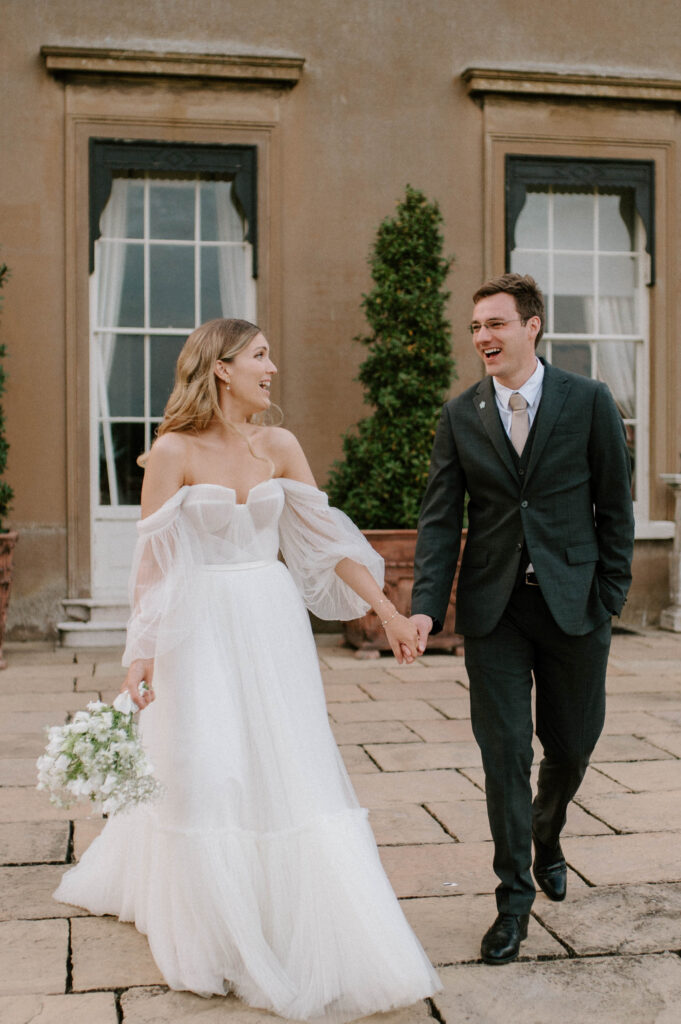 bride and groom walking outside Sibton park house at wilderness reserve 