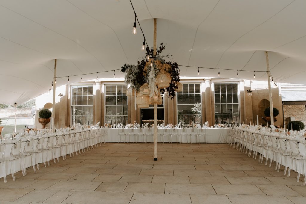 luxury wedding breakfast details boho luxe wedding with neutrals at sibton park estate outside orangery with festoon lights