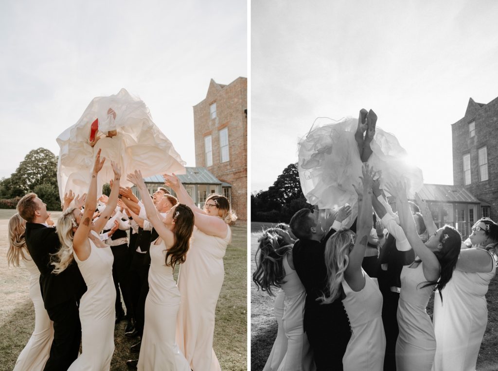 bridesmaids and groomsmen picking up bride and throwing her in the air