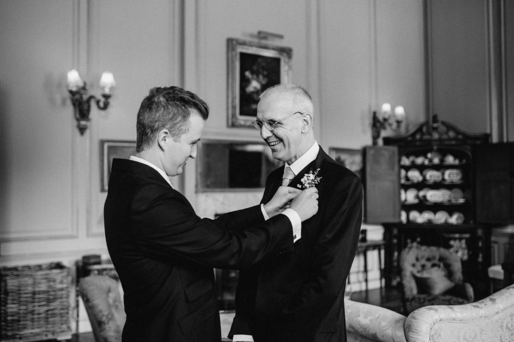 groom helping dad put on button hole at glemham hall