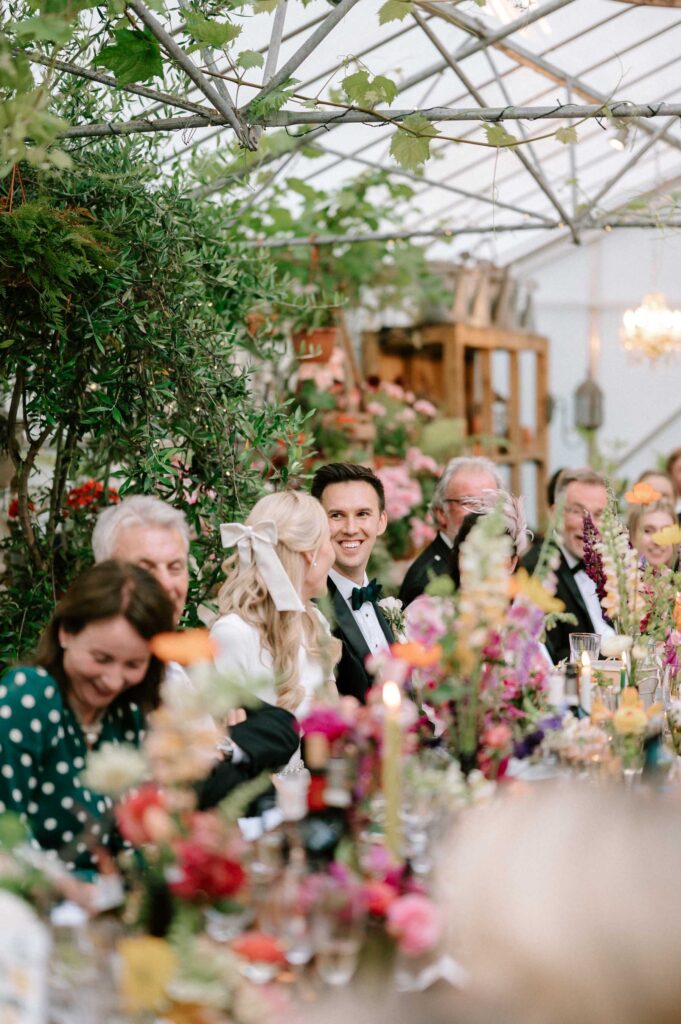 groom smiling at bride during wedding breakfast