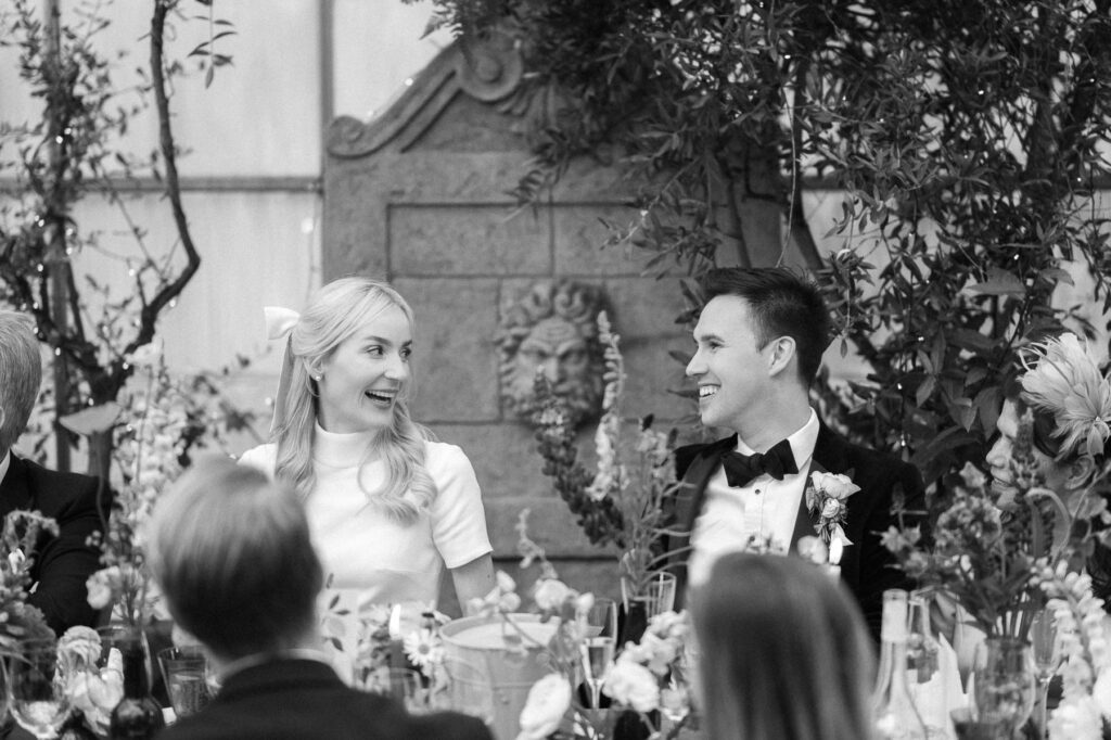 bride and groom reactions during wedding speeches at West Green house gardens