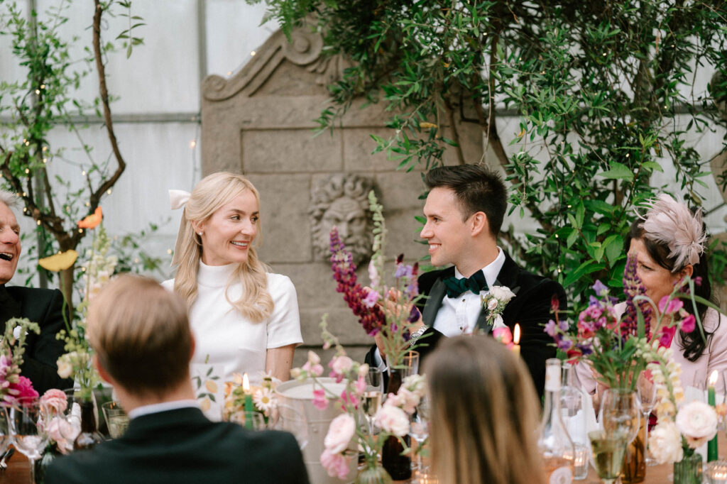 bride and groom reactions during wedding speeches at West Green house gardens