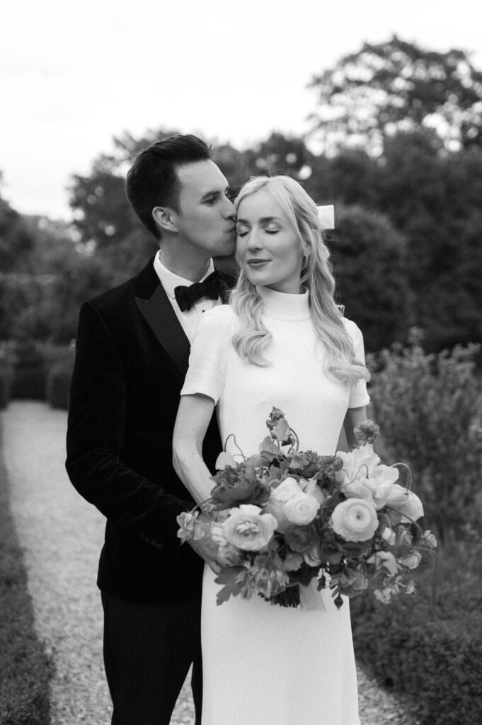 groom kissing bride on forehead