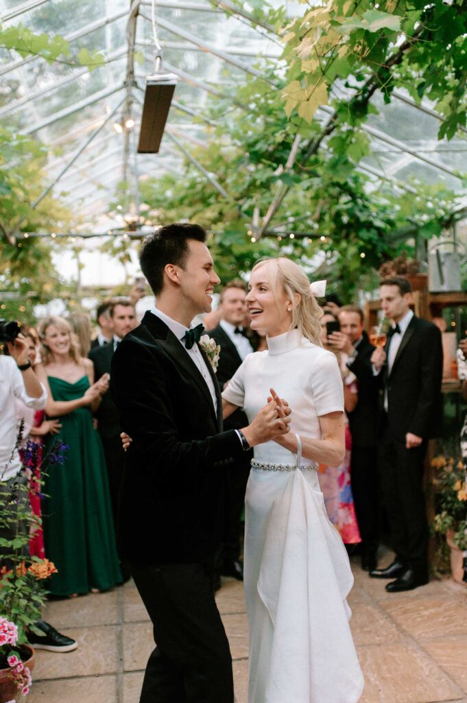 bride and groom smiling during first dance at West Green house gardens