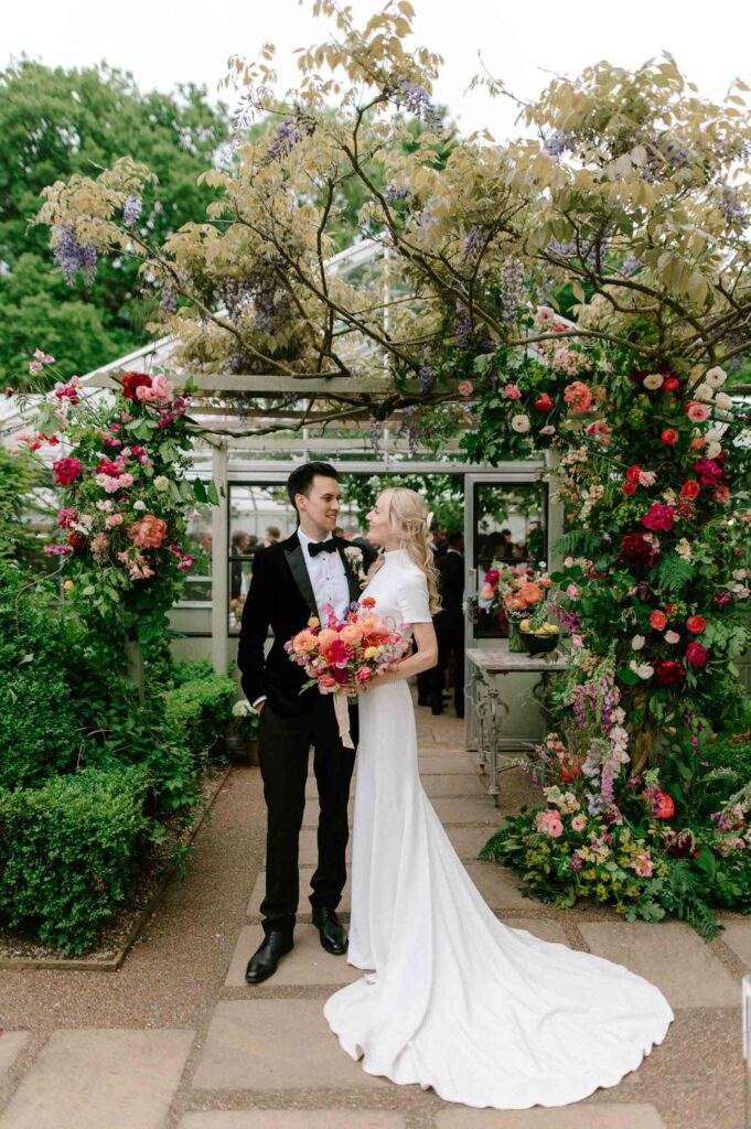 bride and groom smiling standing outside West Green house gardens