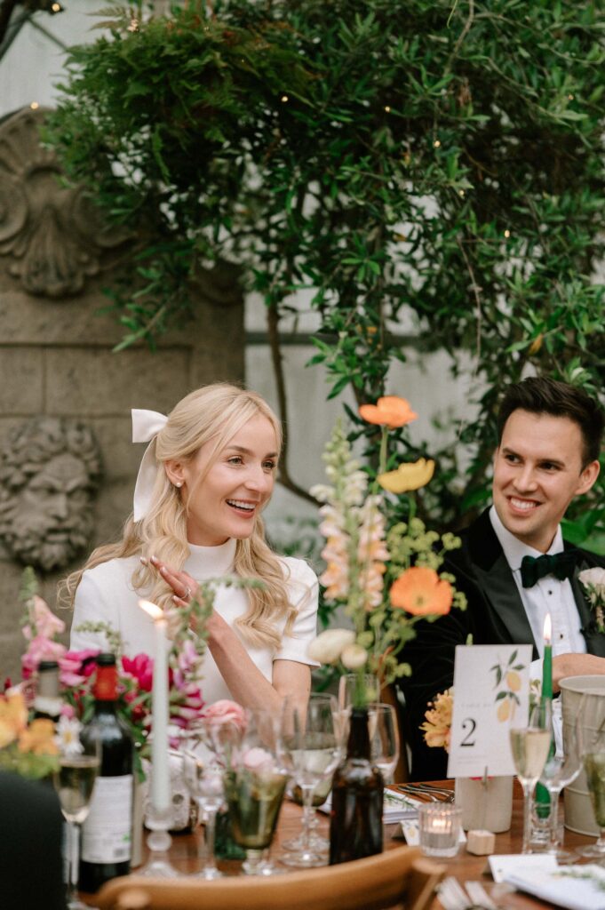 candid moment of bride and groom during wedding speeches