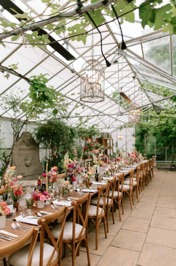 intimate wedding setup in greenhouse with lots of foliage and florals in hampshire