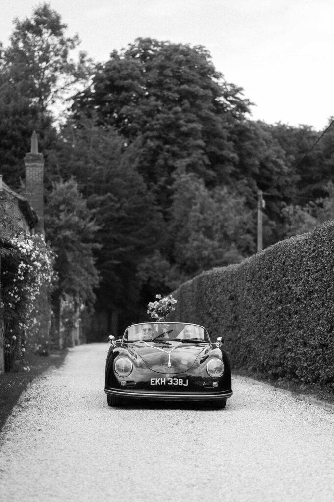 bride and groom driving off after Hampshire ceremony