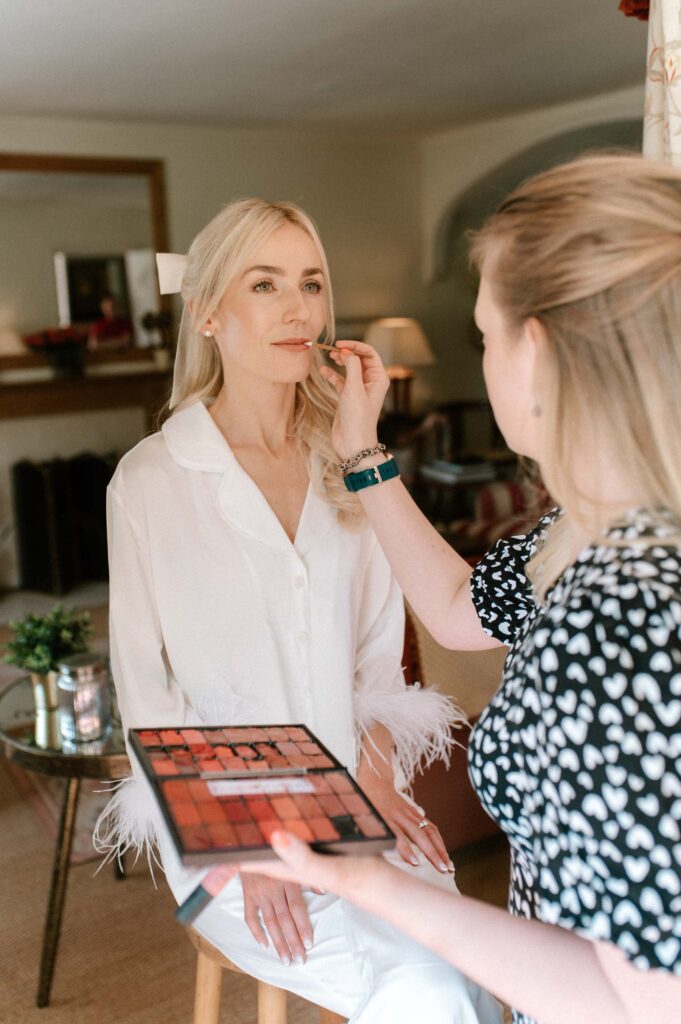bride getting makeup done on wedding morning at London wedding venue
