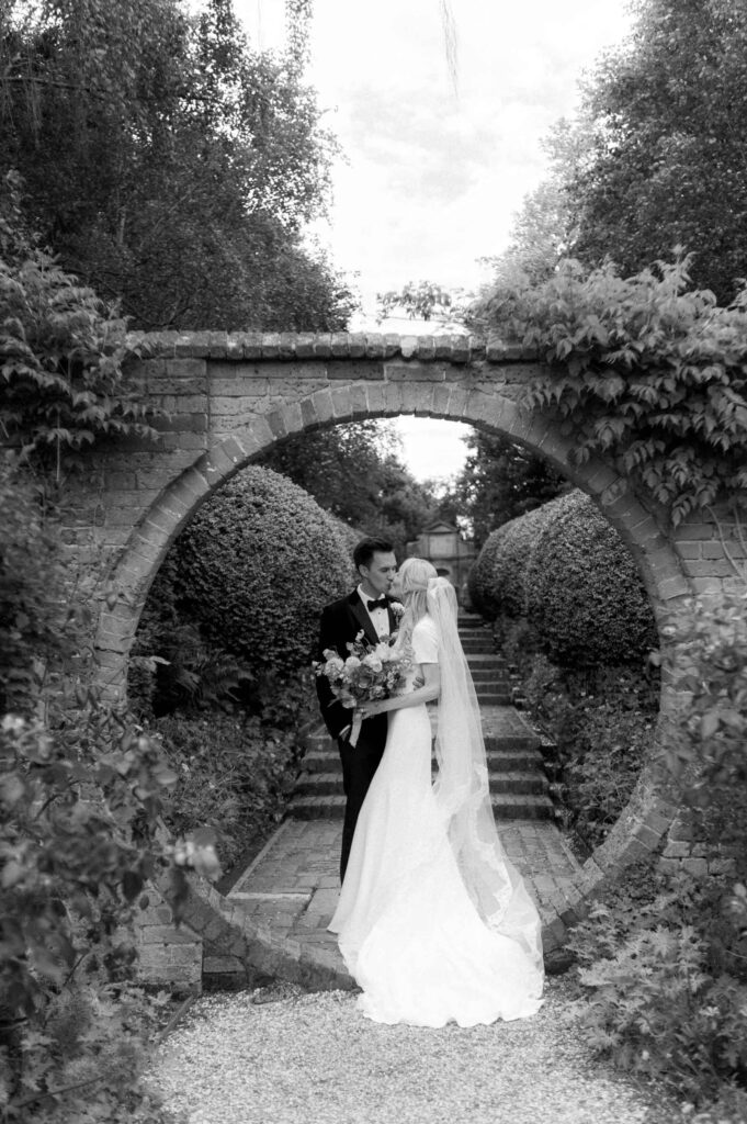 bride and groom in walled garden at West Green house gardens