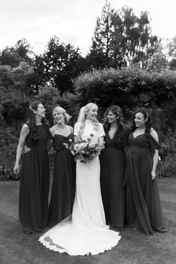 bride and bridesmaids smiling and laughing