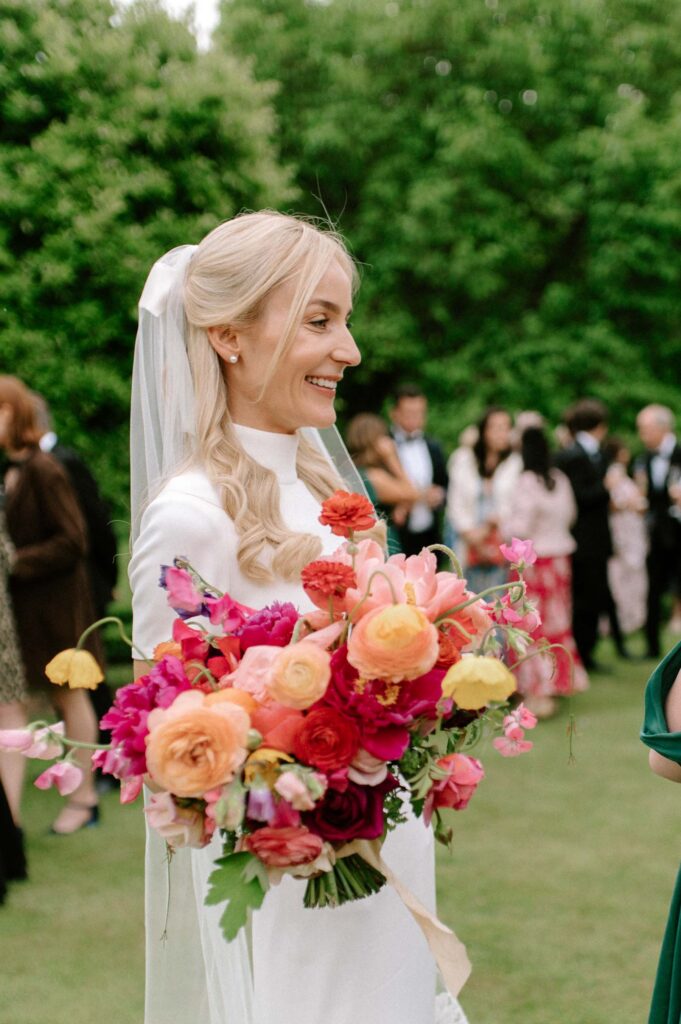 candid moment of bride smiling at guests