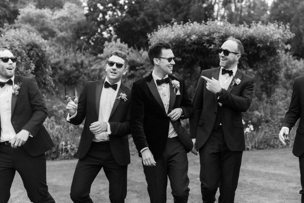 groom joking and laughing with his groomsmen
