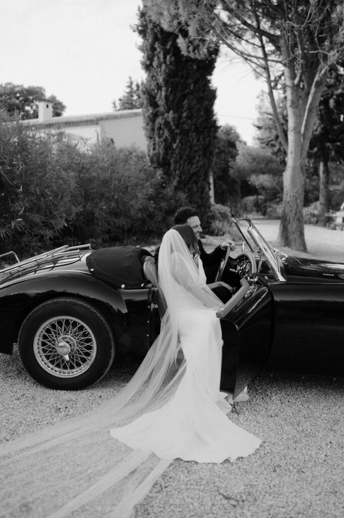 couple in vintage mg at le mas des costes Provence wedding venue