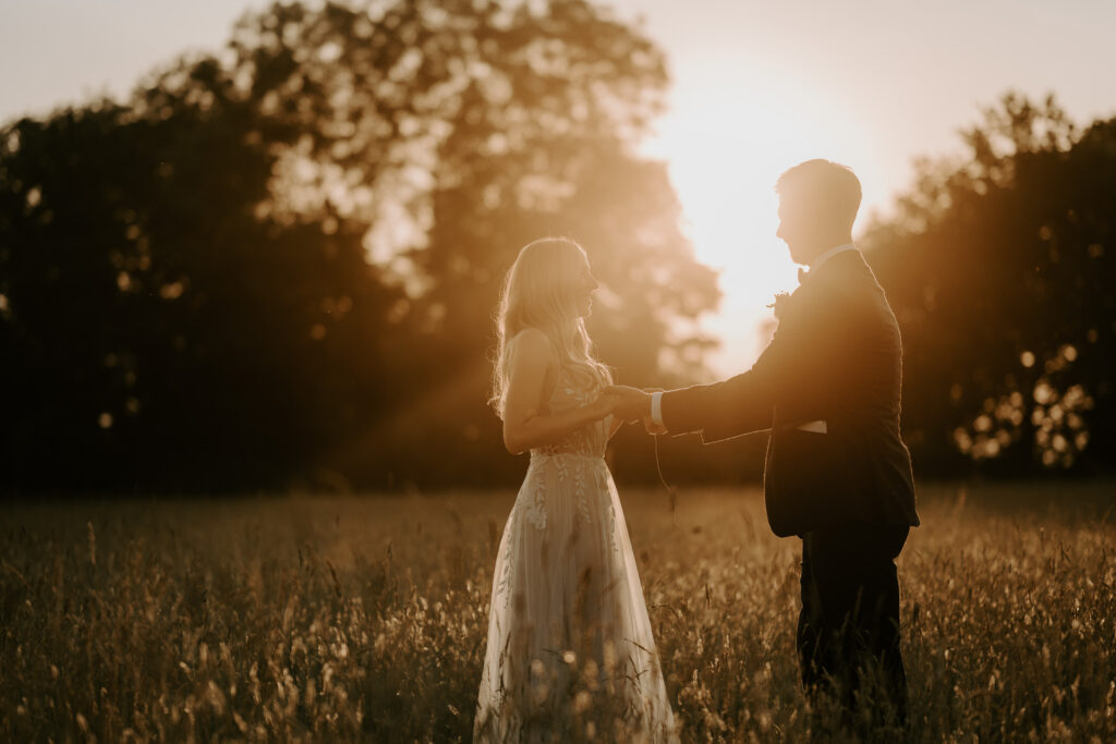 bride and groom at golden hour in a field at Silchester Farm