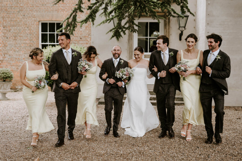 bridal party as aswarby rectory walking towards camera