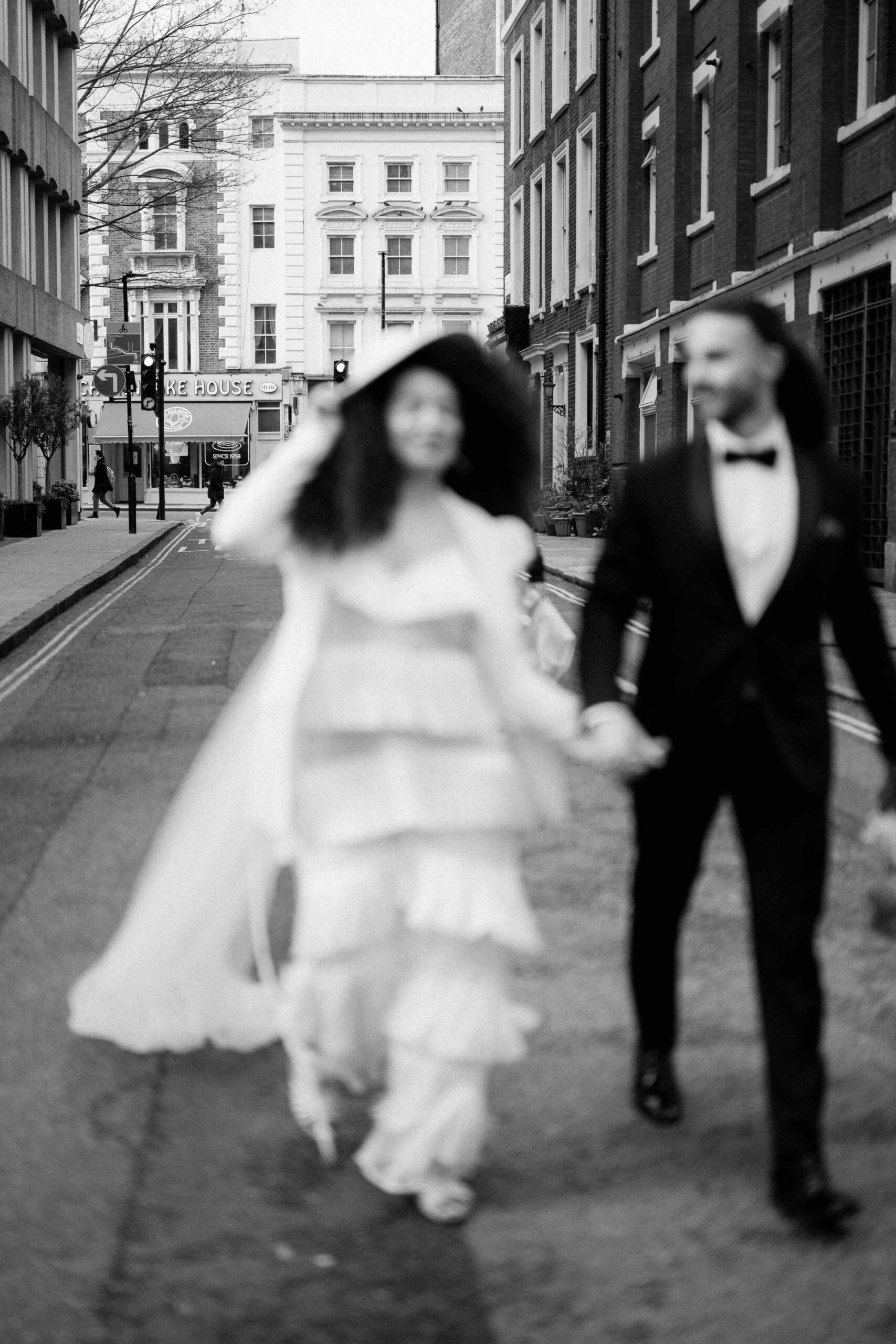 bride and groom walking down street in london
