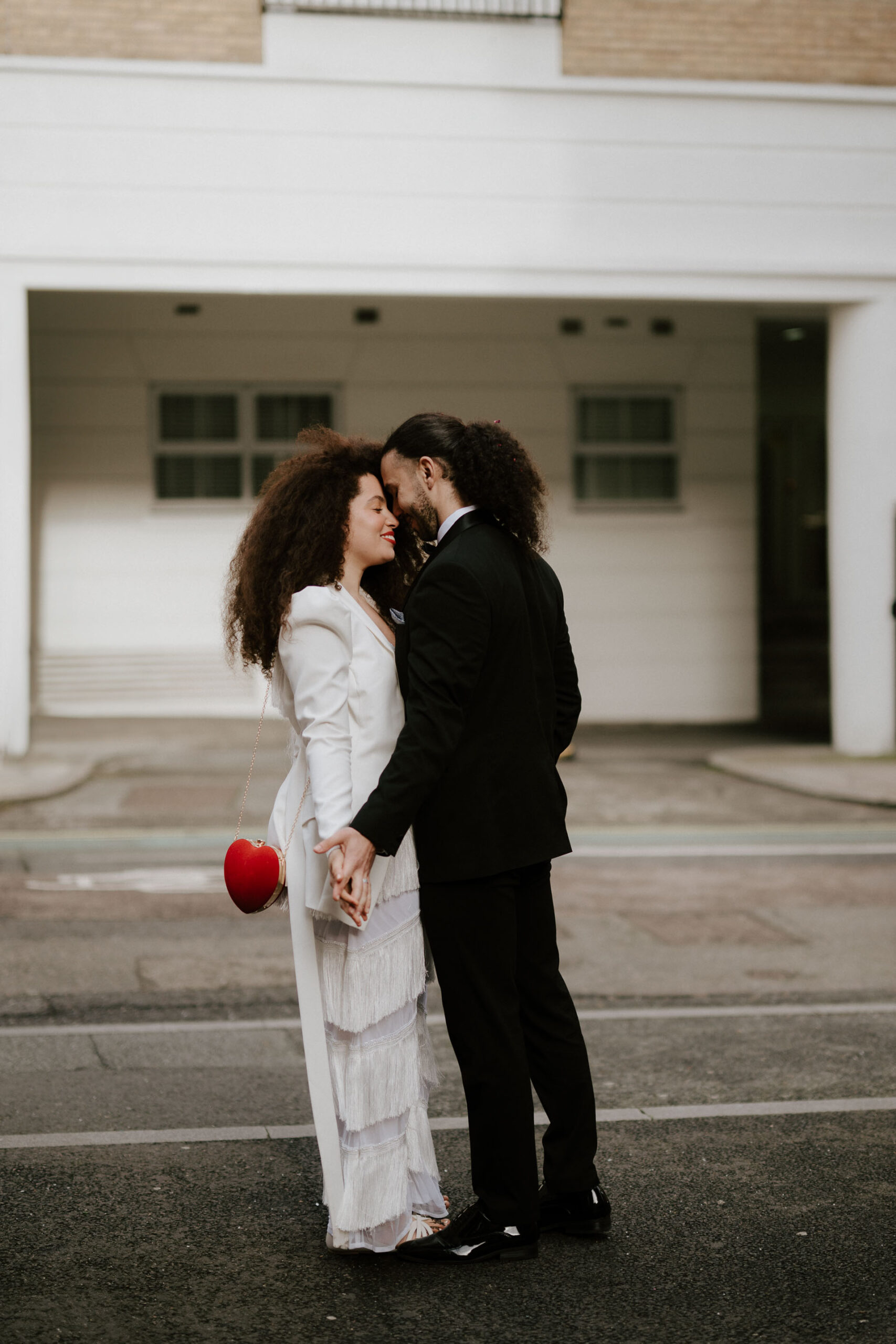 bride and groom embracing in london on the street