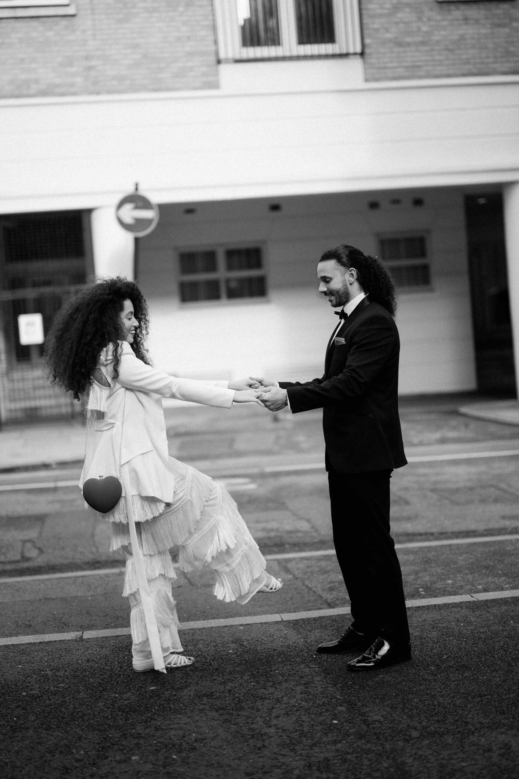 bride and groom dancing on streets of london