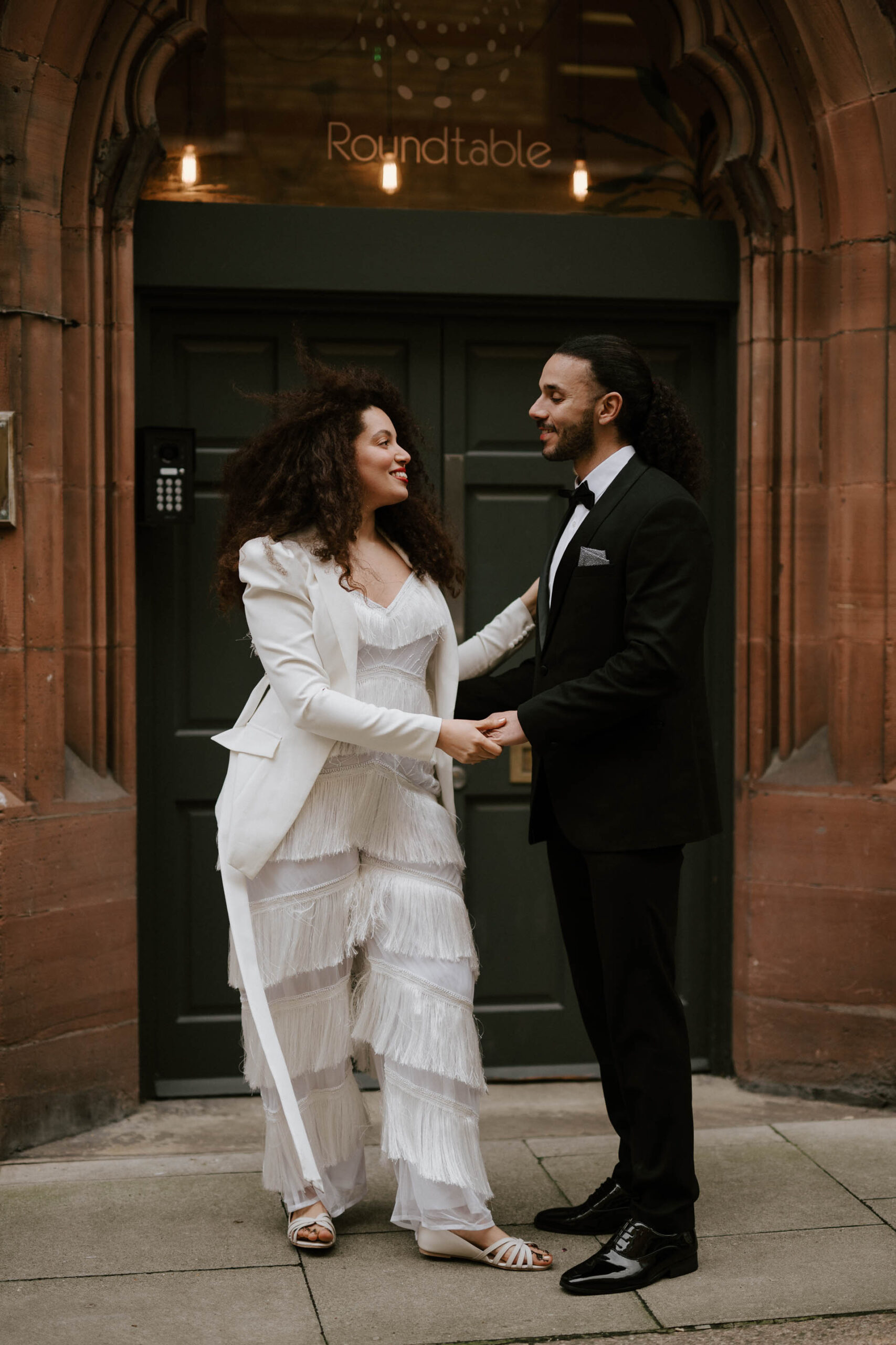 bride and groom dancing on streets of london