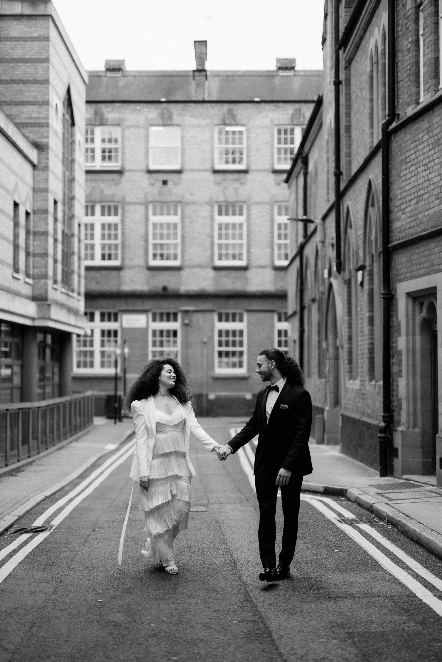 bride and groom walking down streets of london