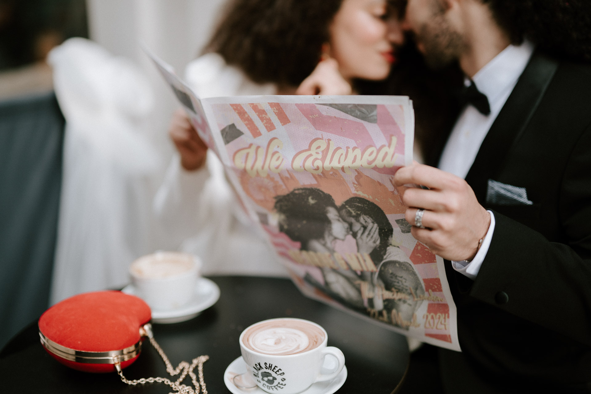 bride and groom at coffee shop drinking coffee reading newspaper