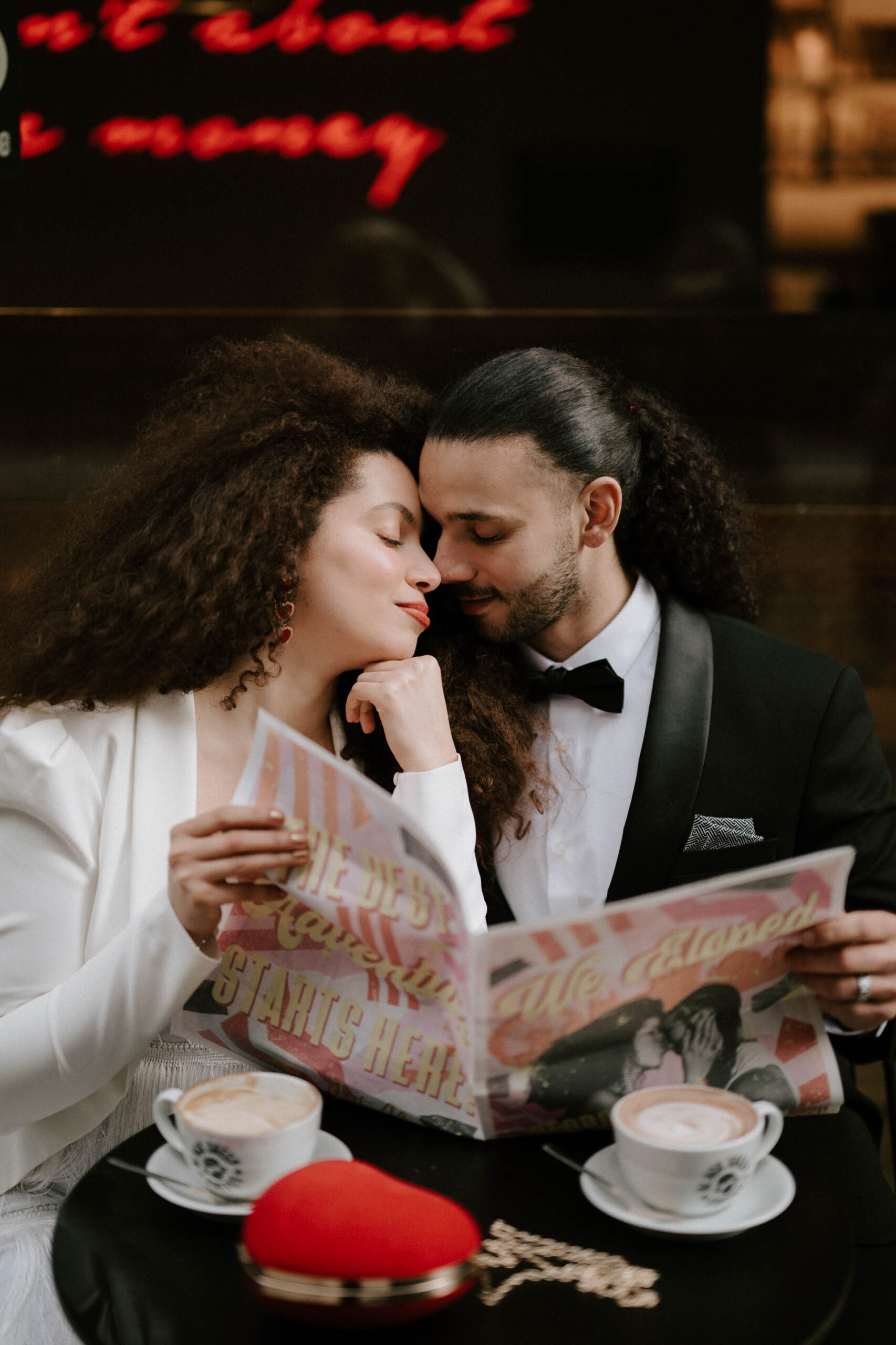 bride and groom at coffee shop drinking coffee reading newspaper