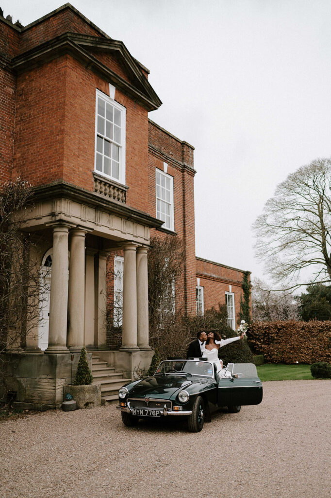 portrait of bride and groom in wedding car