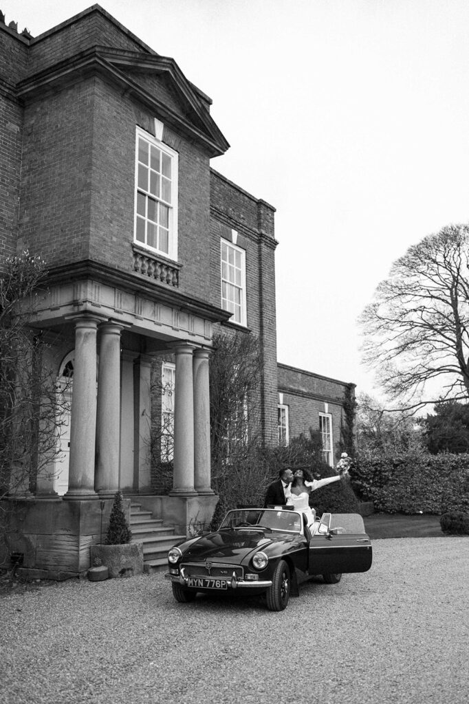 portrait of bride and groom in wedding car