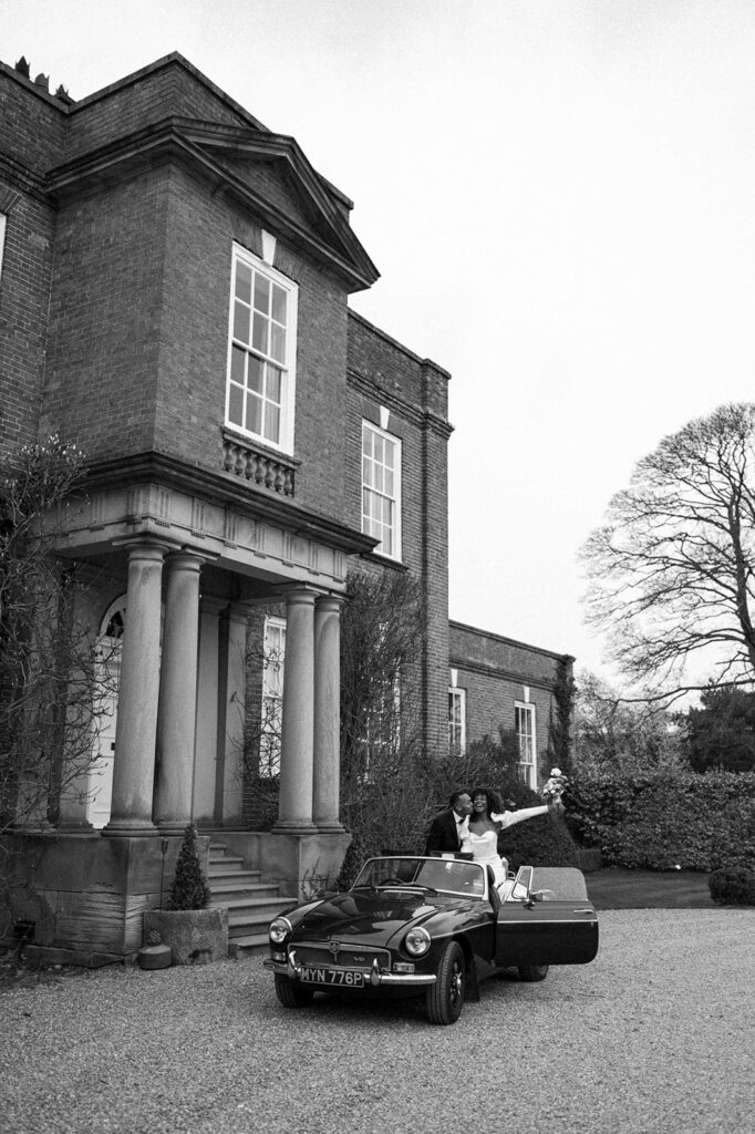 portrait of bride and groom in wedding car