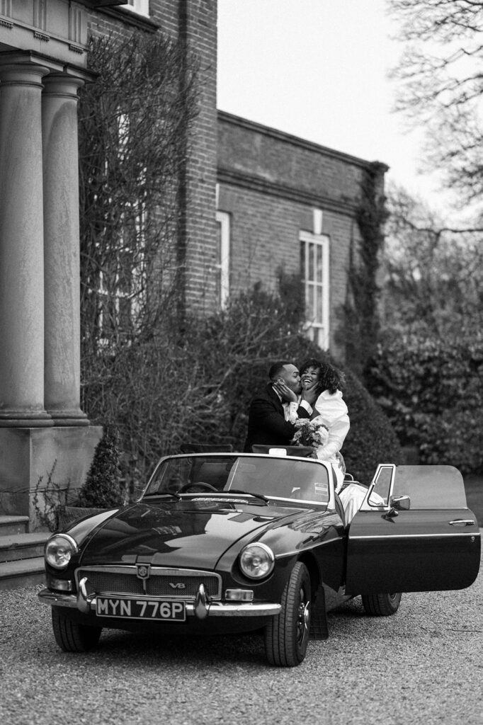 portrait of bride and groom in wedding car