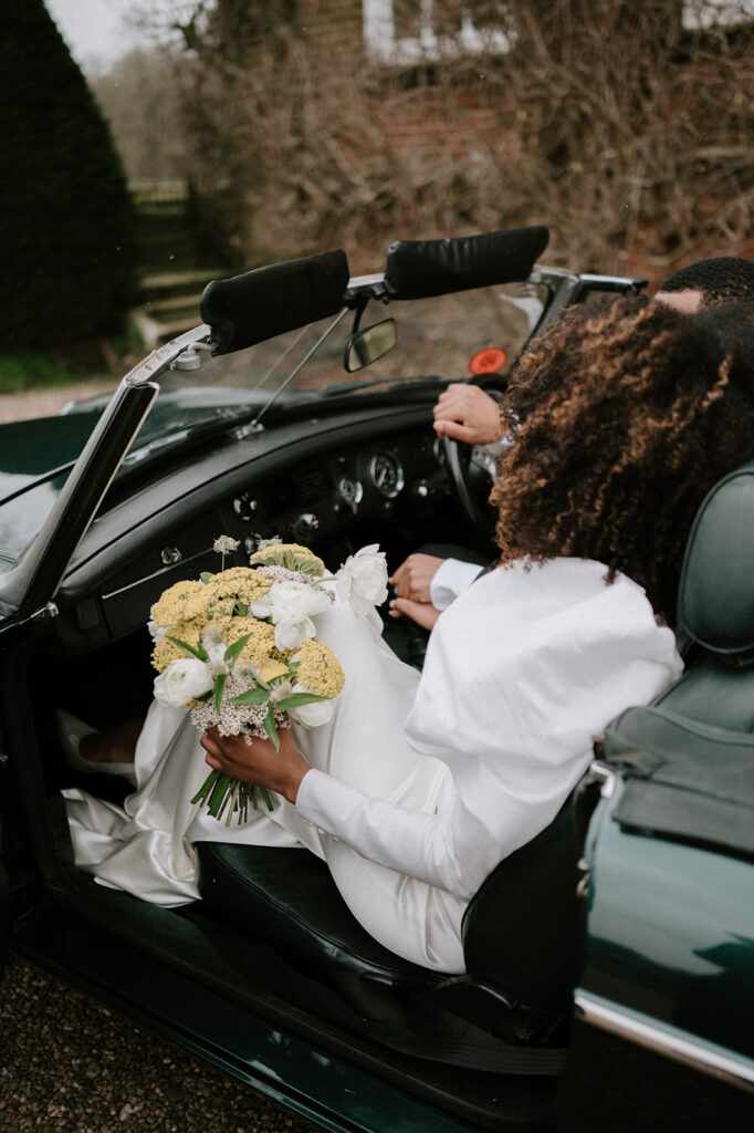 bride and groom in wedding car 