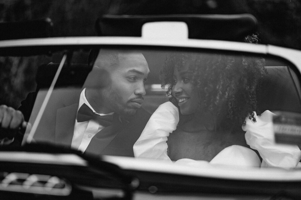 bride and groom in wedding car 