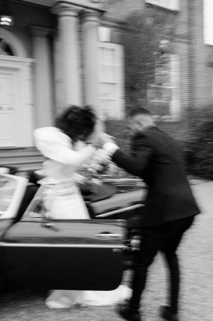 groom helping bride get out of car