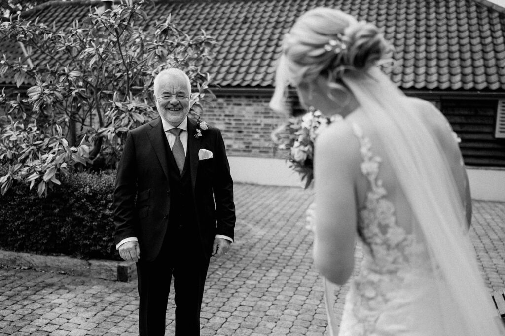 father seeing bride for first time at retreat east