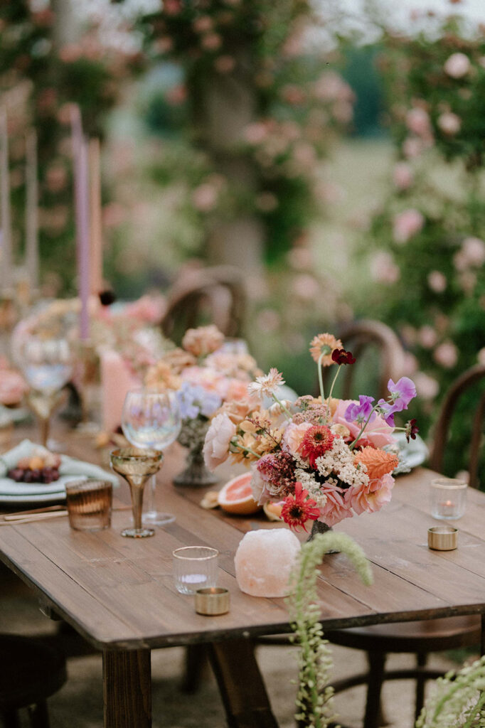 colourful outdoor wedding breakfast set up in gardens of Euridge Manor