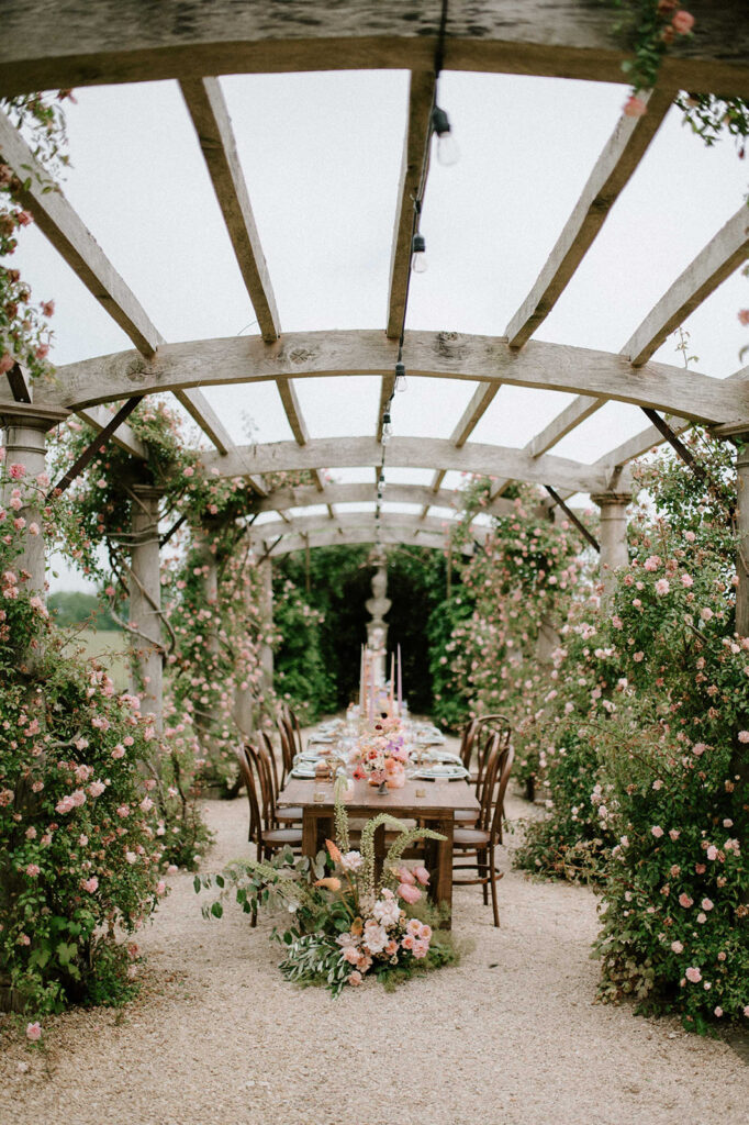 colourful outdoor wedding breakfast set up in gardens of Euridge Manor