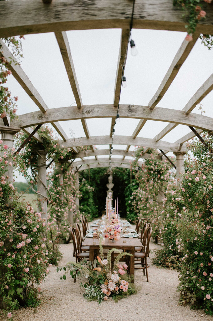 colourful outdoor wedding breakfast set up in gardens of Euridge Manor