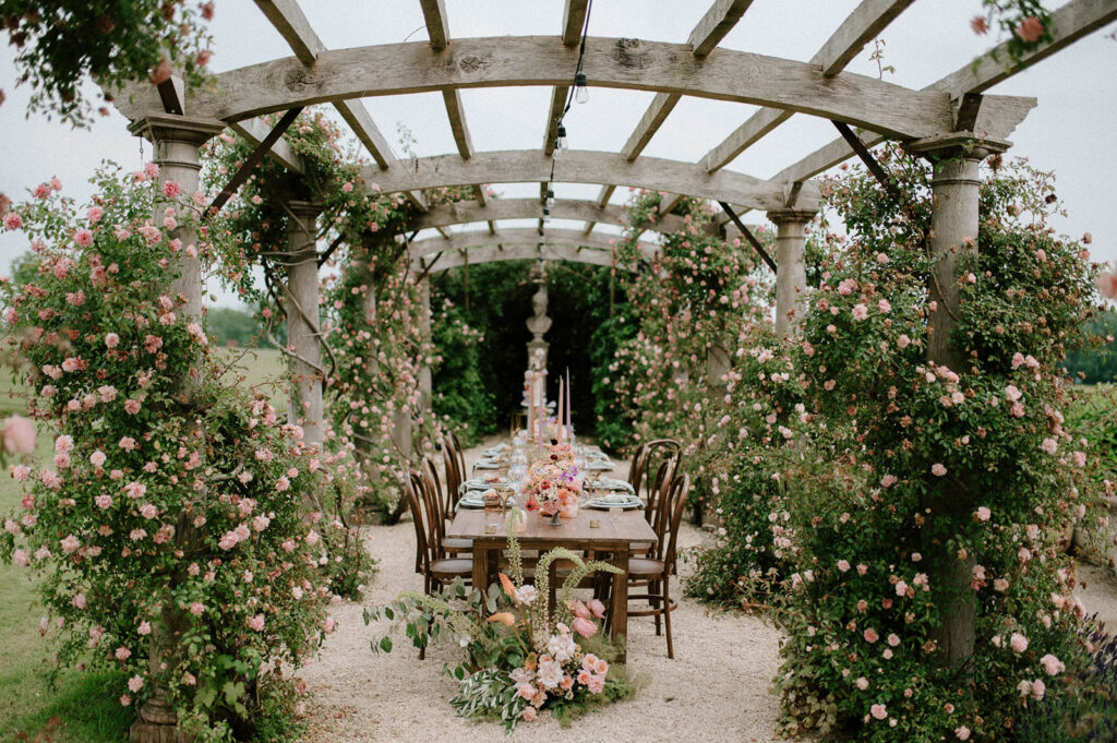 colourful outdoor wedding breakfast set up in gardens of Euridge Manor