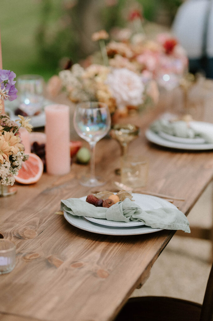 colourful outdoor wedding breakfast set up in gardens of Euridge Manor