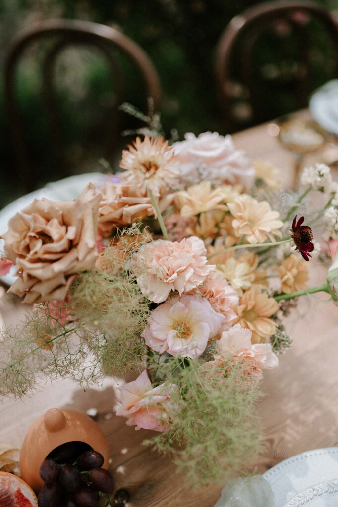 colourful outdoor wedding breakfast set up in gardens of Euridge Manor