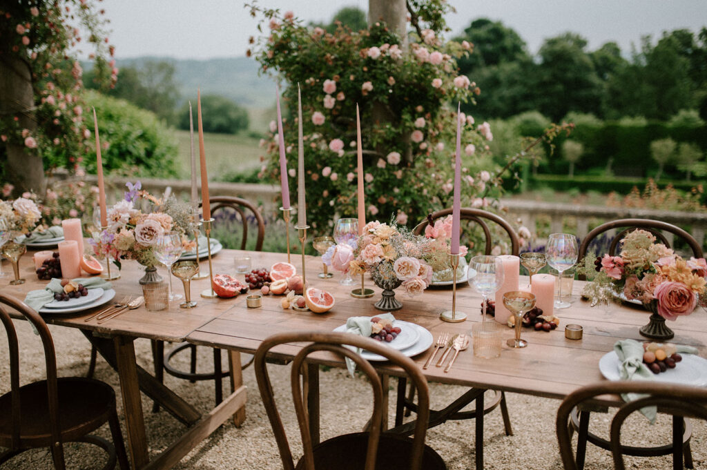 colourful outdoor wedding breakfast set up with spring florals and candlesticks at Euridge manor