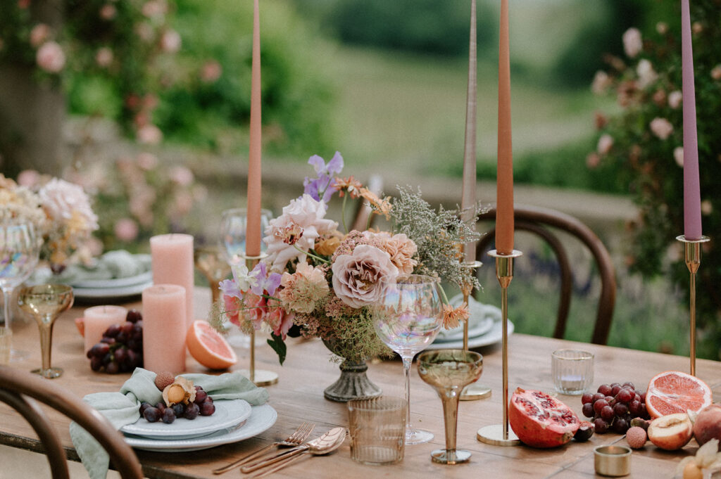colourful outdoor wedding breakfast set up with spring florals and candlesticks at Euridge manor