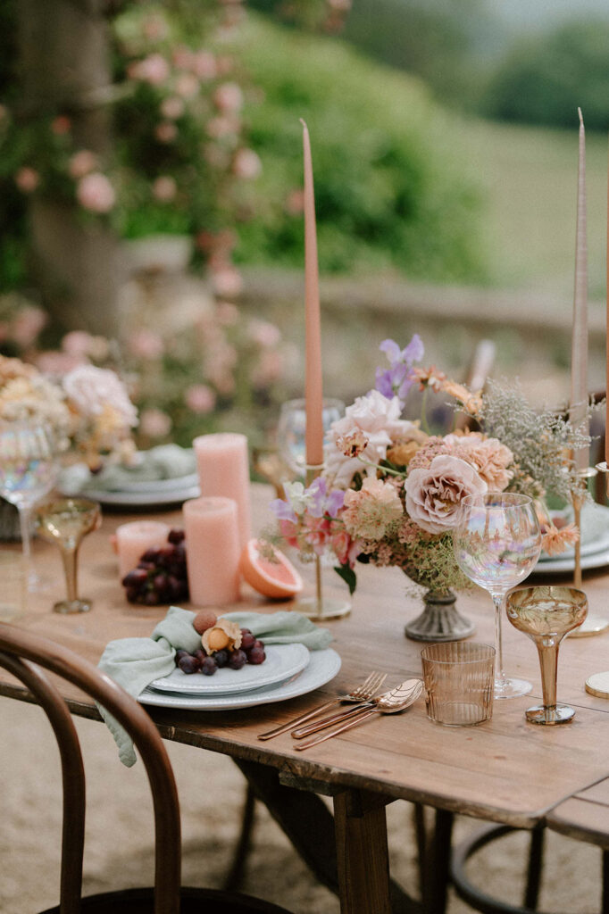 colourful outdoor wedding breakfast set up with spring florals and candlesticks at Euridge manor