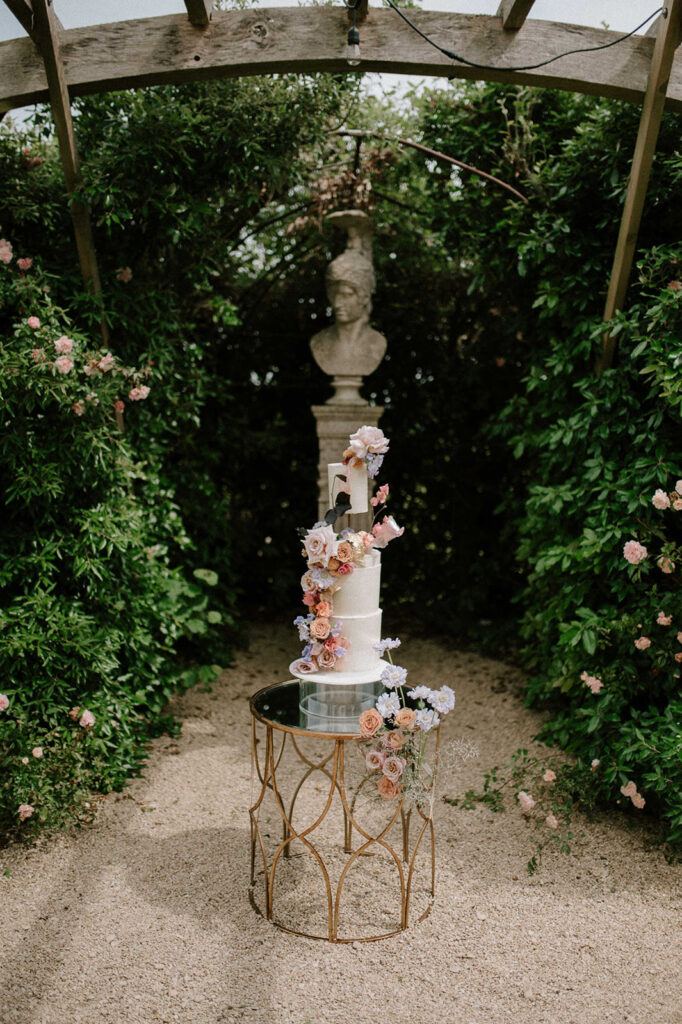colourful 3 tier wedding cake in gardens of euridge manor