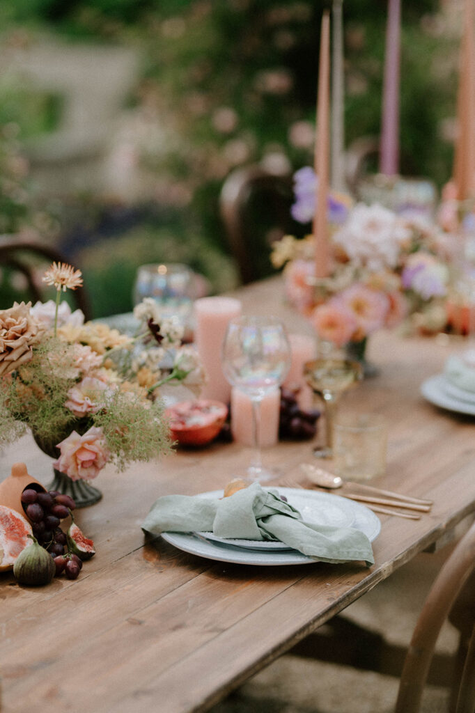 colourful outdoor wedding breakfast set up with spring florals and candlesticks at Euridge manor